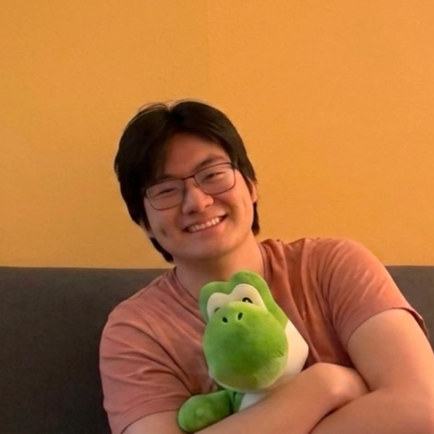 Darren holding a green plush